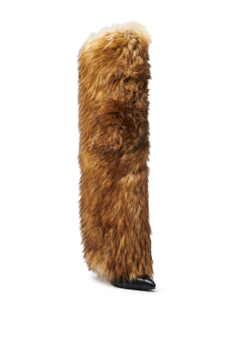 The AZALEA WANG LANGDON BROWN THIGH-HIGH FUR LUXE BOOT features brown faux fur with black and tan accents, a pointed black toe, chunky heel, and luxe faux leather construction, shown against a white background.