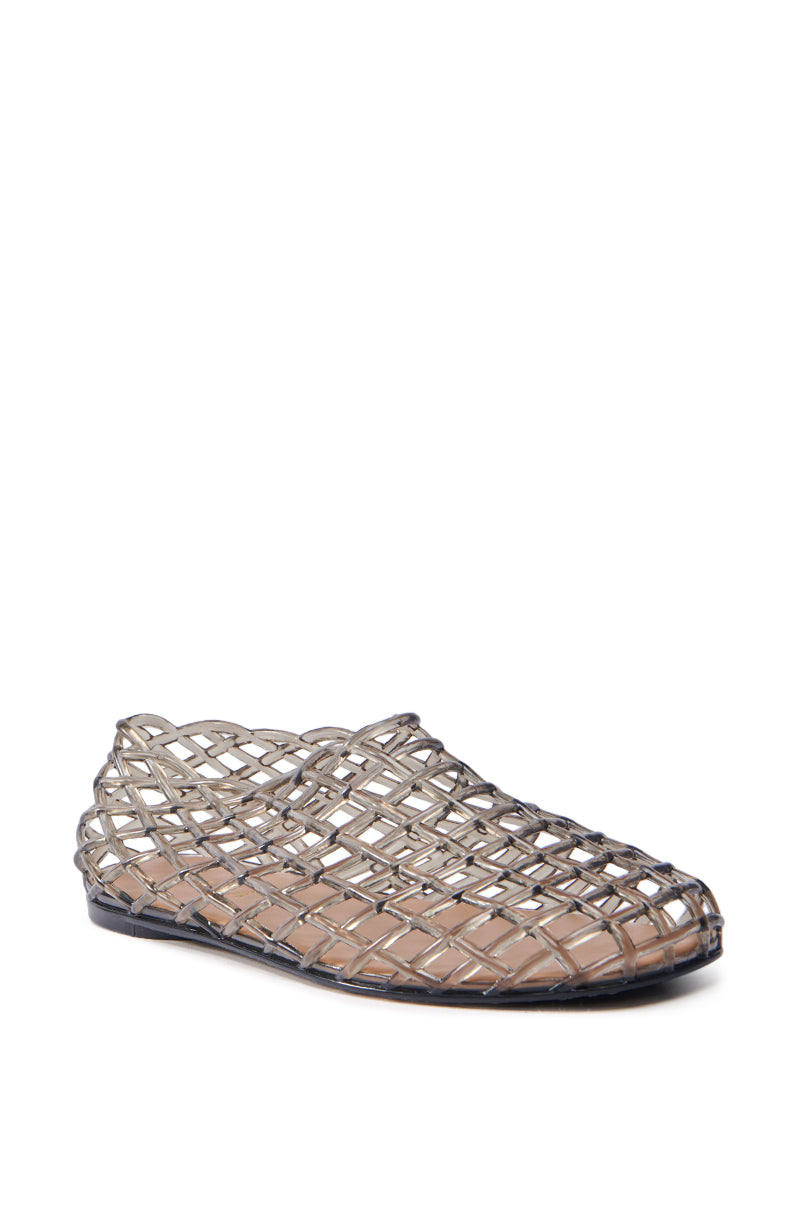 The AKIRA LINUS BLACK FLAT is a translucent slip-on PVC flat with a lattice pattern and flat sole, showcased on a plain white background. Its woven design gives it a lightweight and airy appearance.