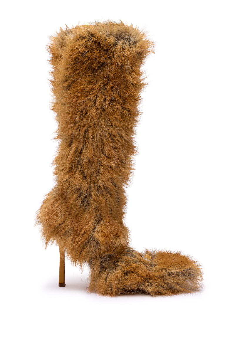 The AZALEA WANG LOURDANNE TAN FUR LACE UP STILETTO BOOT is a tall, knee-high stiletto with shaggy brown faux fur, lace-up detail, and a pointed toe that extends past the sole for dramatic flair.
