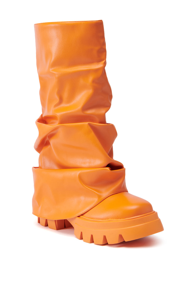 Introducing the AZALEA WANG MATE ORANGE BOOTIE: a slouchy, vibrant boot featuring a chunky, textured sole. Made from faux leather, it boasts a folded, relaxed upper design and an eye-catching color that truly makes a statement.