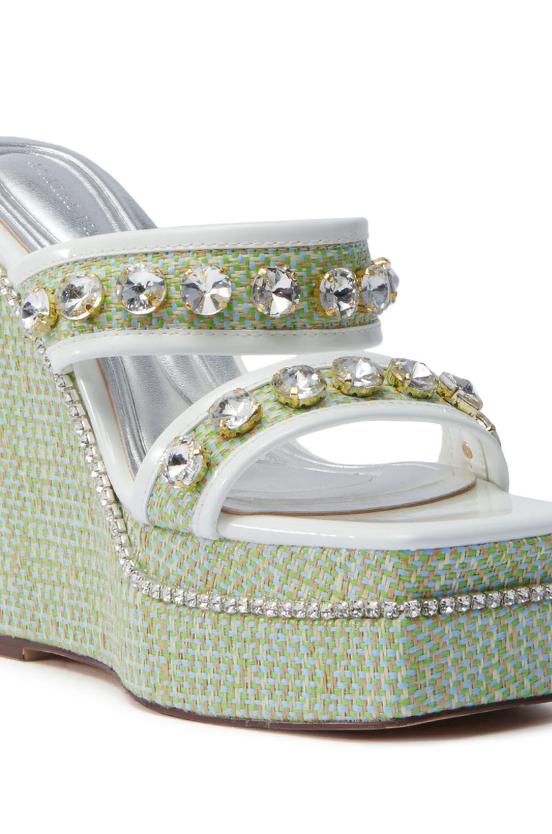 The AZALEA WANG NIOMA GREEN EMBELLISHED WEDGE SANDAL features a chic high wedge with multiple straps enhanced by large silver rhinestones. The light green and blue woven pattern complements its glossy white platform, ideal for fans of chunky heels.