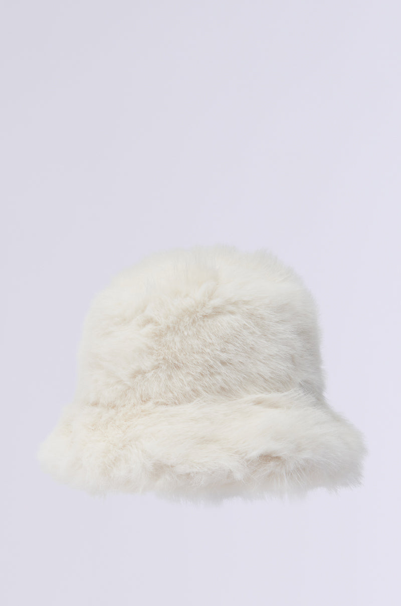 The BABY IT'S COLD OUTSIDE faux fur bucket hat in ivory is a fluffy white accessory, perfect for enhancing your winter wardrobe, showcased against a plain light background.