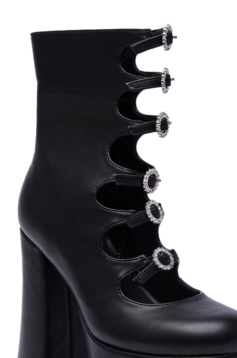 The AZALEA WANG OMLEE Black Ultra High Platform Bootie features five oval cutouts with crystal-embellished buttons, a chunky heel, and a smooth leather finish for standout style.