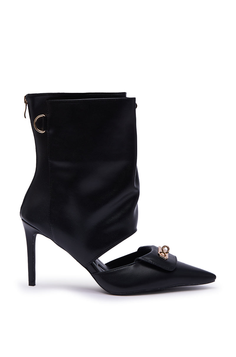 The AZALEA WANG SARVESH BLACK CUTOUT STILETTO BOOTIE is a black pointed-toe bootie with cutout details, loafer-style front flap, and gold hardware accents, displayed on a white background.