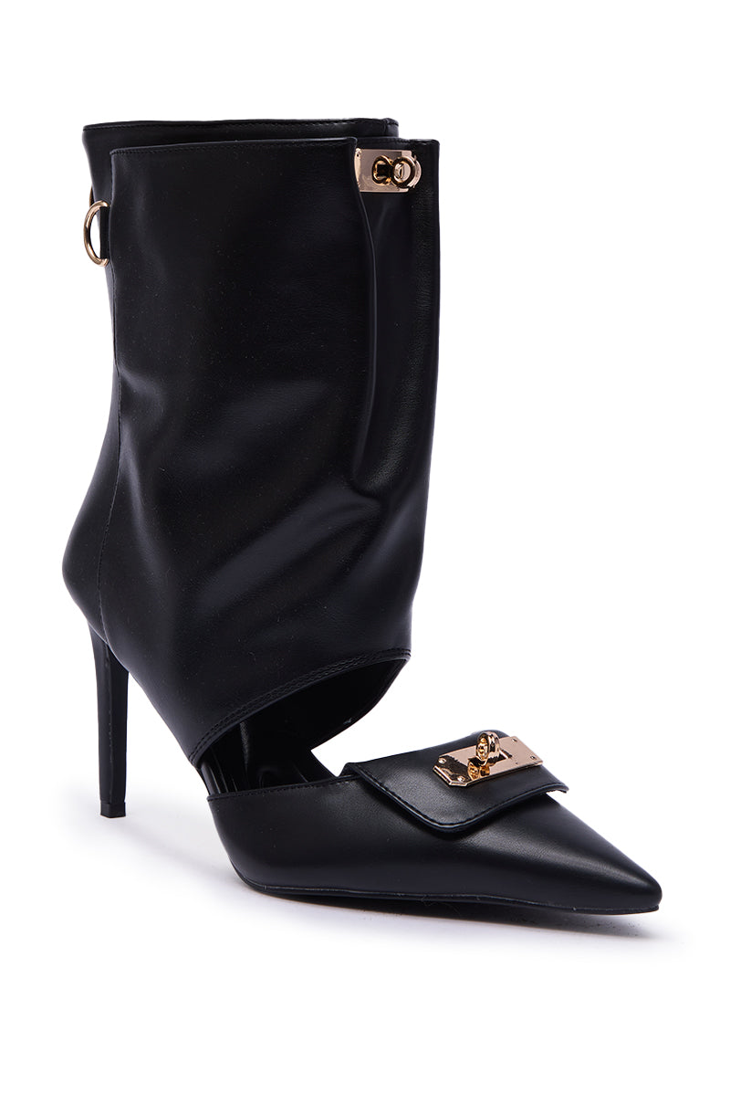 The AZALEA WANG SARVESH BLACK CUTOUT STILETTO BOOTIE features a pointed toe, gold buckle accents, and a unique folded-over ankle design with gold hardware.