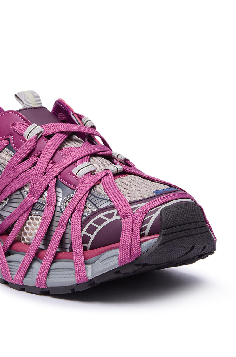 The AZALEA WANG SELIE PURPLE LACE UP SNEAKER features a gray mesh base, bright pink crisscross straps, and a thick black-and-gray platform sole for a bold, modern style.