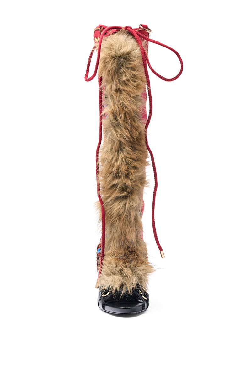 The AZALEA WANG SHAINE BLACK MULTI GLADIATOR STITCH AND FUR SANDAL features a knee-high design with a black open toe, red laces, and a bold brown faux fur panel on the front, highlighting its distinctive faux fur stiletto style against a white background.