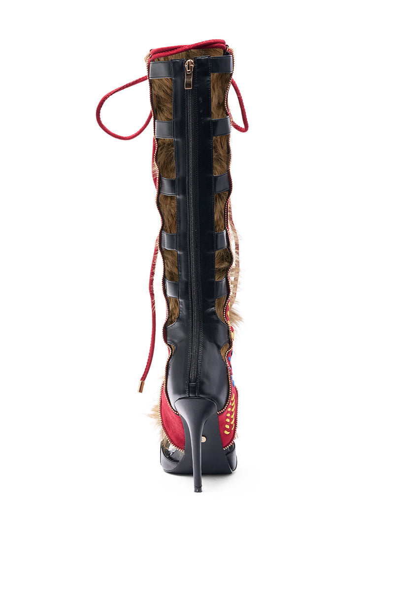 The AZALEA WANG SHAINE BLACK MULTI GLADIATOR STITCH AND FUR SANDAL features black and red sections, faux fur accents, gladiator stitching, a lace-up design, and a center zipper for a bold look.