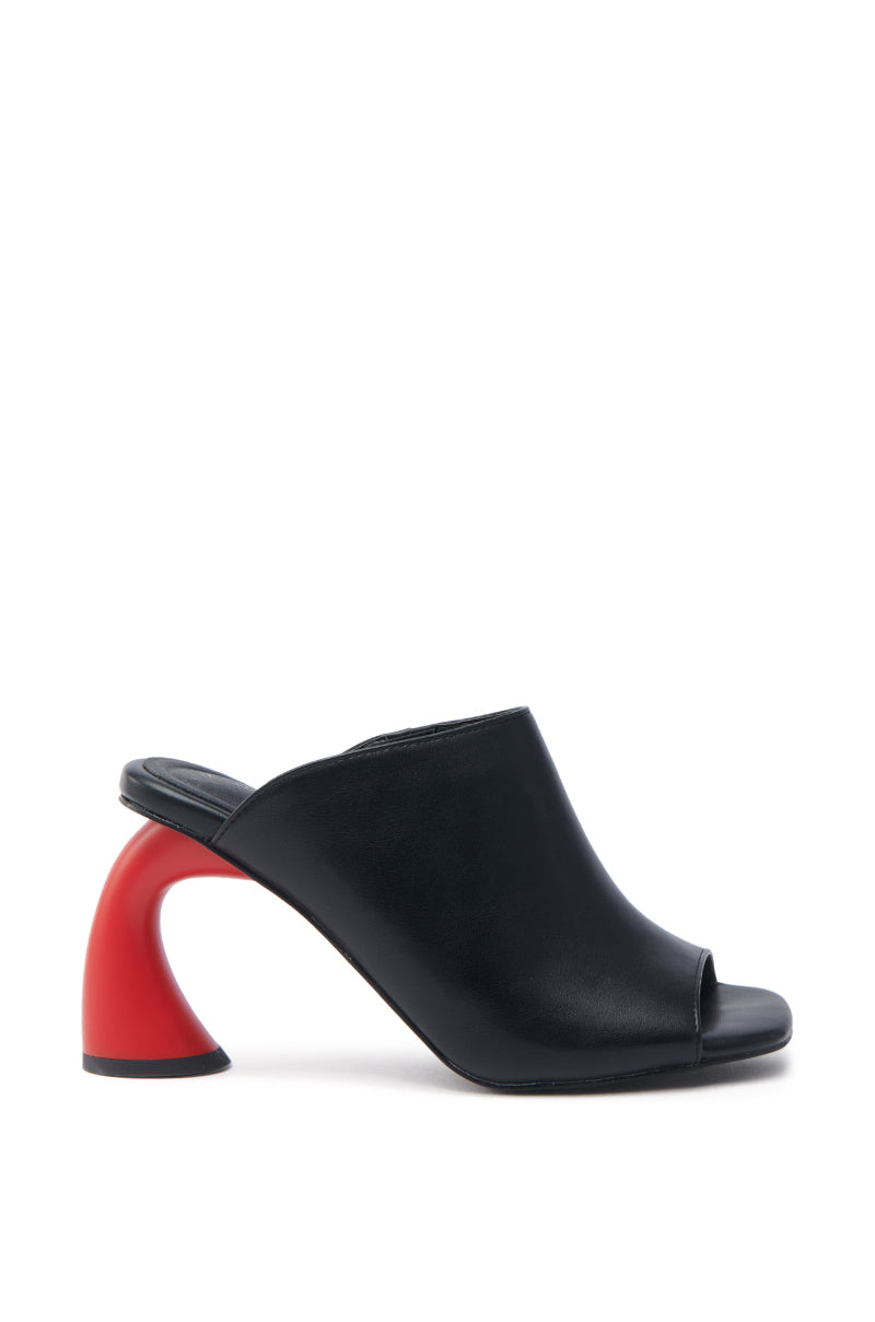 The AZALEA WANG SIDLE Black Slip-On Mule Sandal features a faux leather design with a distinctive red curved heel and an open-toe style, displayed in a side view against a white background.