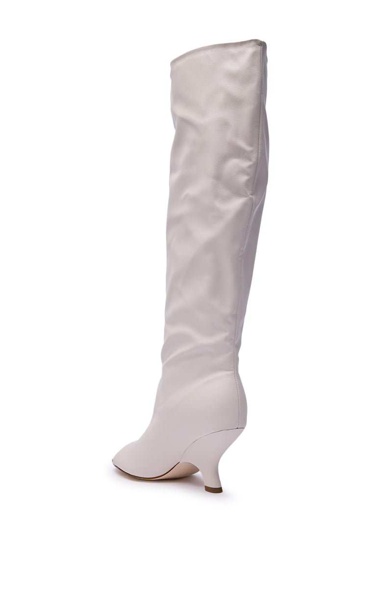The AZALEA WANG SIZANI White Wedge Slouchy Boot, featuring white faux leather and a wedge heel, is displayed against a plain white background.