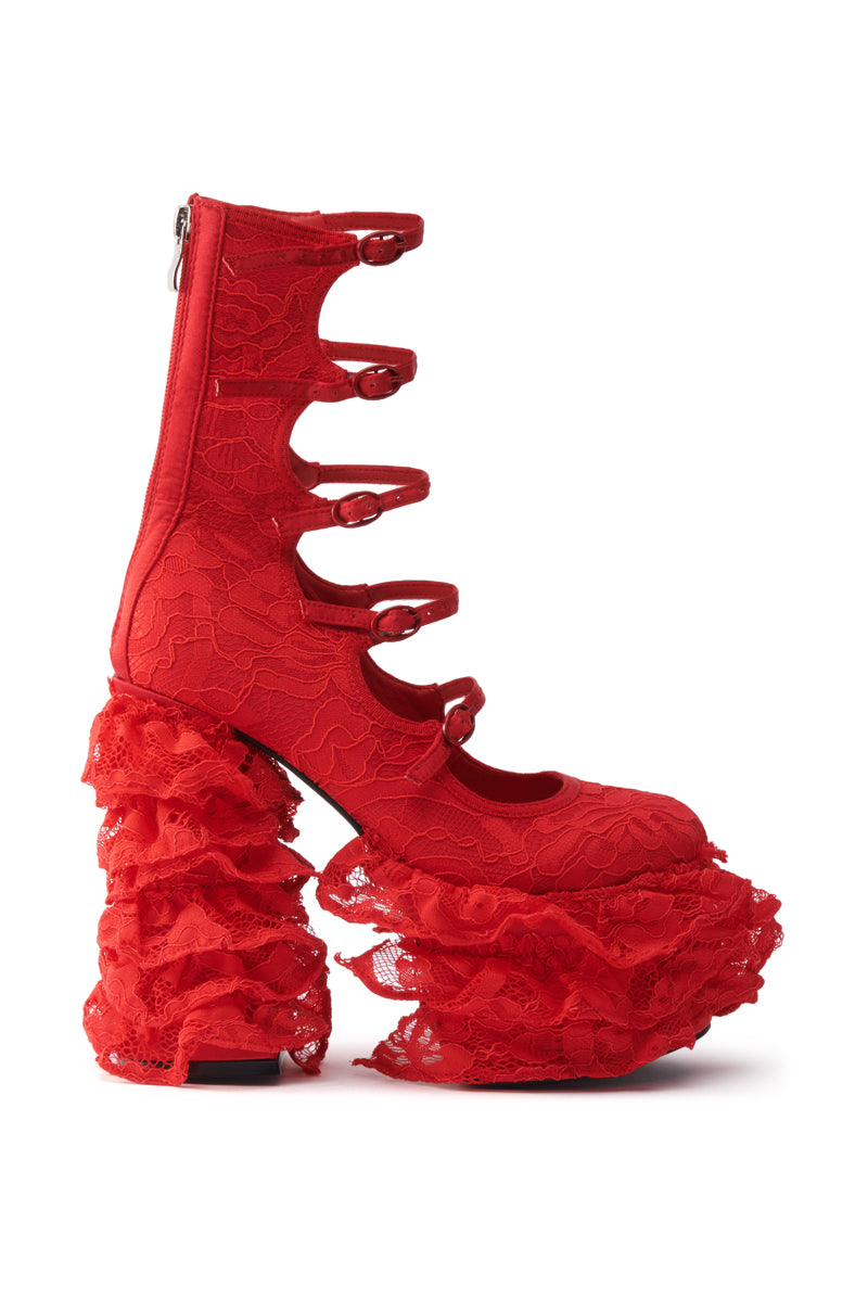 The AZALEA WANG SPREENE RED CHUNKY PUMP is a vibrant red high-heeled shoe featuring lace textile, five buckle straps, and dramatic ruffled platform and heel all wrapped in matching red lace.