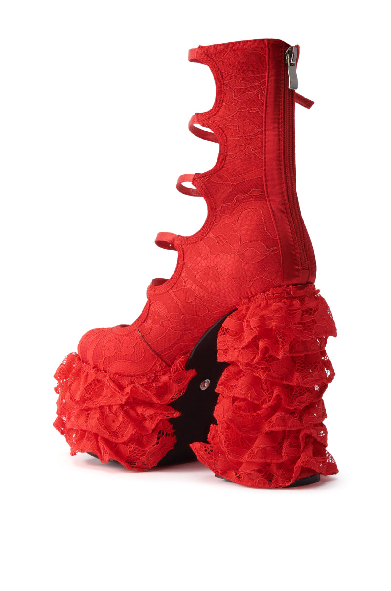 The AZALEA WANG SPREENE RED CHUNKY PUMP features a bold red design, lace platform sole, multiple straps, back zipper, and dramatic ruffled lace accents at the heel and platform.