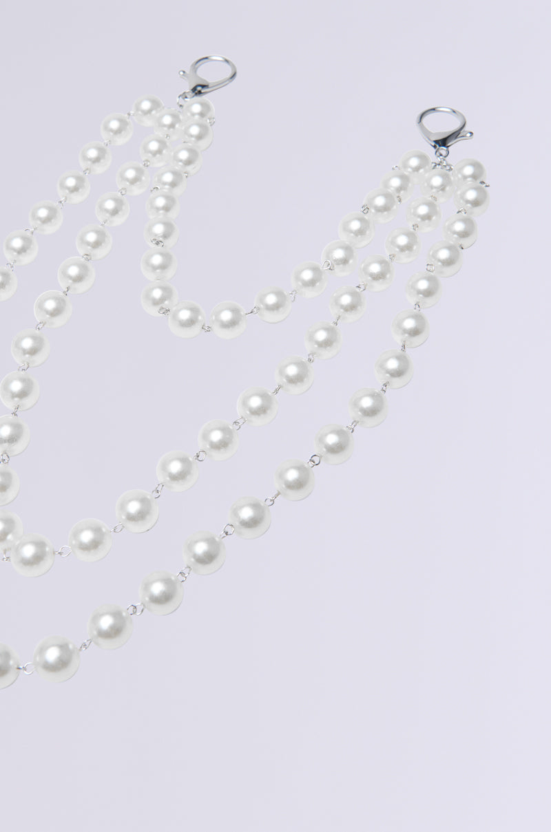 The STYLE ME UP PEARL PANTS CHAIN features three delicate faux pearl strands with evenly spaced shiny white pearls connected by small metal links, displayed in a descending pattern on a light gray background.