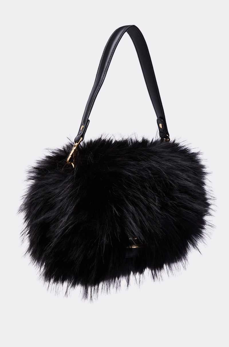 The REALLY LIKE THAT FAUX FUR PURSE IN BLACK features a plush faux fur exterior and a sleek faux leather handle, shown against a plain light background.