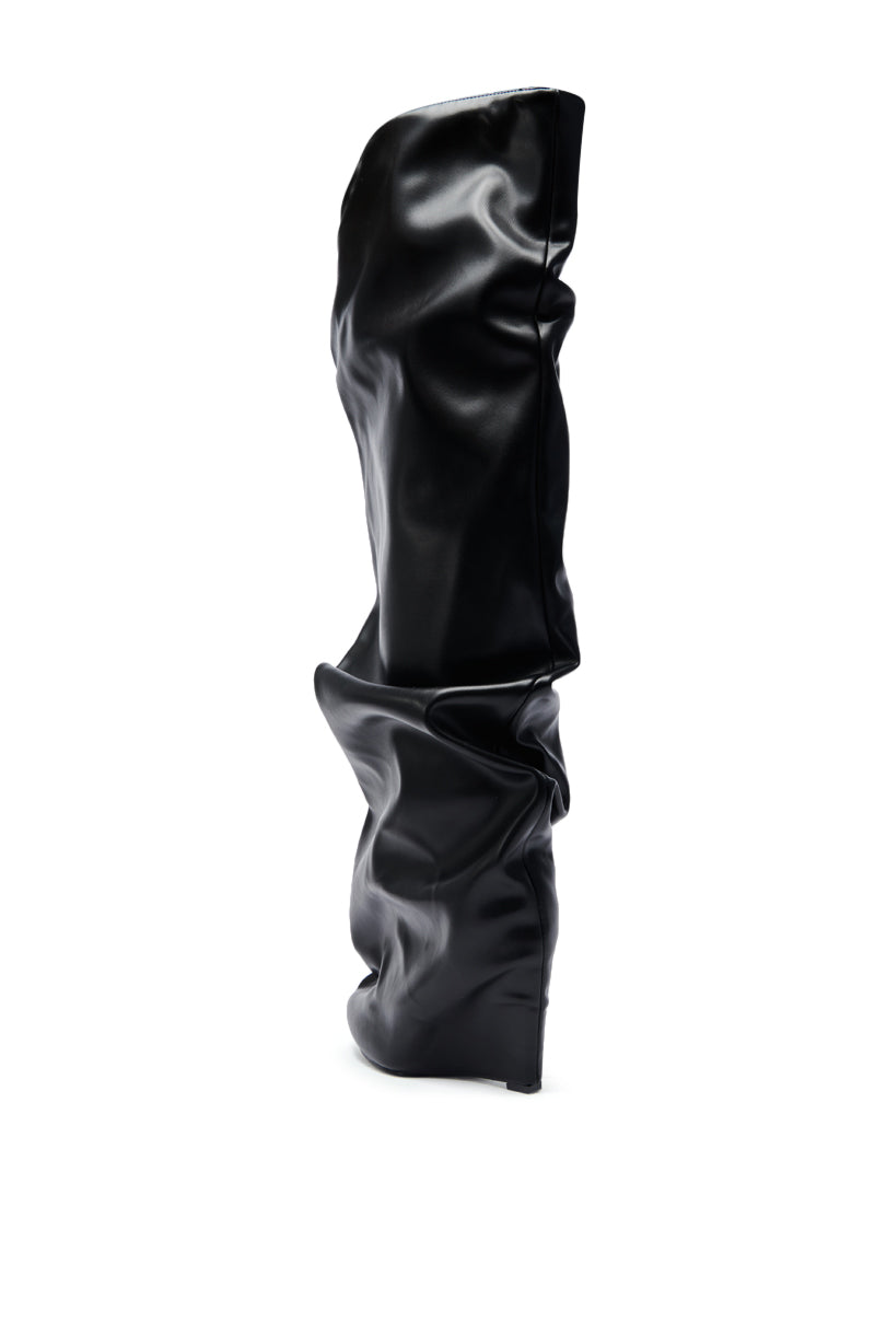 The AZALEA WANG TEUILA BLACK RUCHED WEDGE BOOT features a pointed toe, high wedge heel, shiny faux leather, and a slouchy knee-high shaft, shown here in black on a white background.