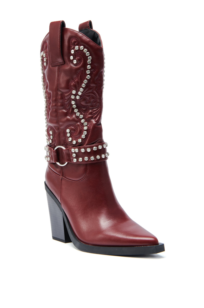 The AZALEA WANG UMBRA BURGUNDY WESTERN BOOTIE is a maroon boot with a pointed toe, chunky high heel, silver studs, Baroque-style stitching and embroidery, plus an ankle strap with silver hardware.