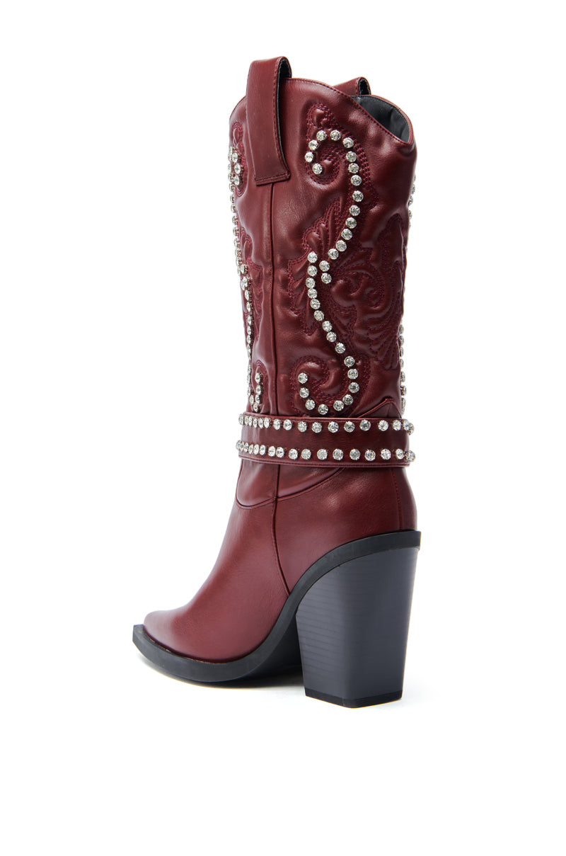 The AZALEA WANG UMBRA BURGUNDY WESTERN BOOTIE features maroon faux leather, a high block heel, decorative stitching, and rows of silver studs around the shaft and ankle. Shown on a white background at an angle highlighting the side and heel.