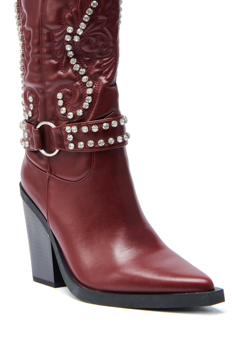 A close-up of the AZALEA WANG UMBRA BURGUNDY WESTERN BOOTIE, featuring burgundy faux leather, a pointed toe, high block heel, baroque embroidery, and two rows of rhinestones at the ankle and upper shaft.