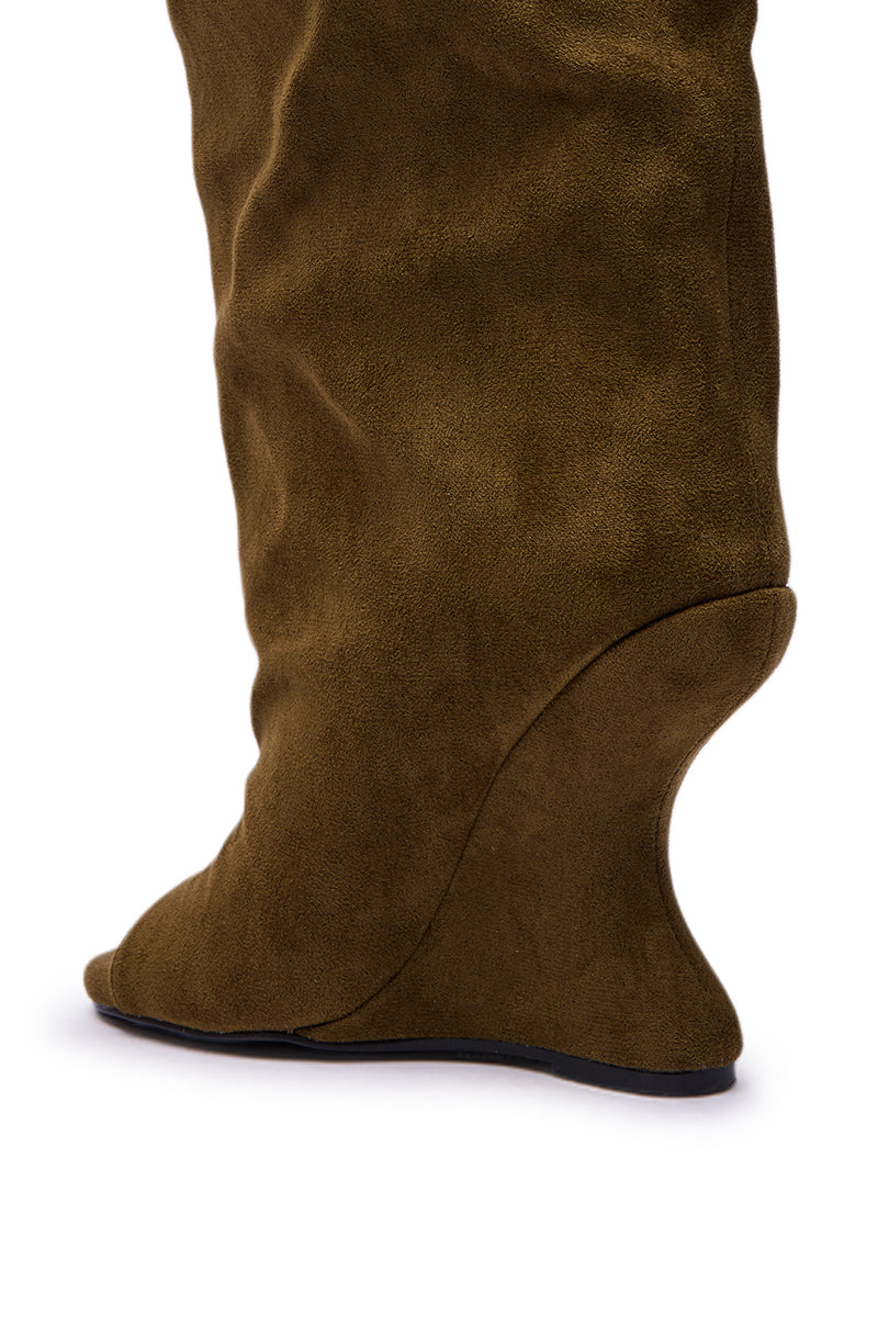 Close-up of the AZALEA WANG VINCENT OLIVE FAUX SUEDE OPEN TOE WEDGE BOOT, featuring a sculpted curved wedge heel and slightly pointed open toe, shown from the side against a white background.