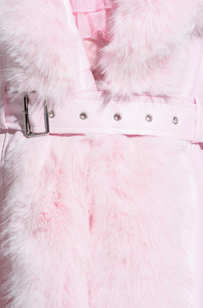 Close-up of the VIVIAN FUR TRIM COAT showcasing its fluffy faux fur texture in a soft and plush pale pink color. The coat features a shiny belt and buckle, with the main panel and collar made from this luxurious material, complemented by a quilted satin lining that adds extra warmth.