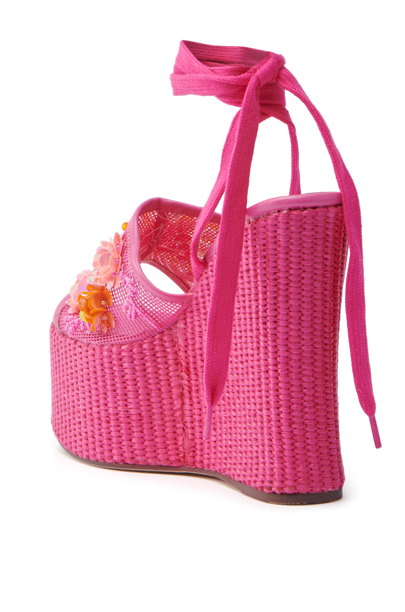 Discover the AZALEA WANG VONDA PINK WEDGE SANDAL, boasting an espadrille-style woven texture with floral embellishments, a tall platform sole, and adjustable laces for a chic, stylish, and comfortable fit.