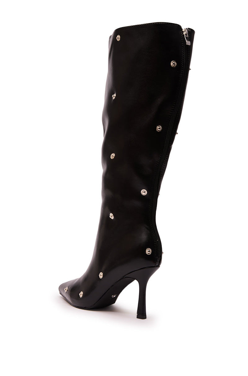 The AZALEA WANG VULTURE BLACK SHERPA LINED BOOT is a sleek black knee-high faux leather boot featuring a pointed toe, round silver studs, back zipper, and cozy sherpa lining.