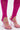 Close-up of feet in clear pink high-heeled sandals with transparent straps, paired with the MAIN MOMENT STRETCH LACE JUMPSUIT’s bright pink sheer floral lace stirrup leggings against a plain white background.