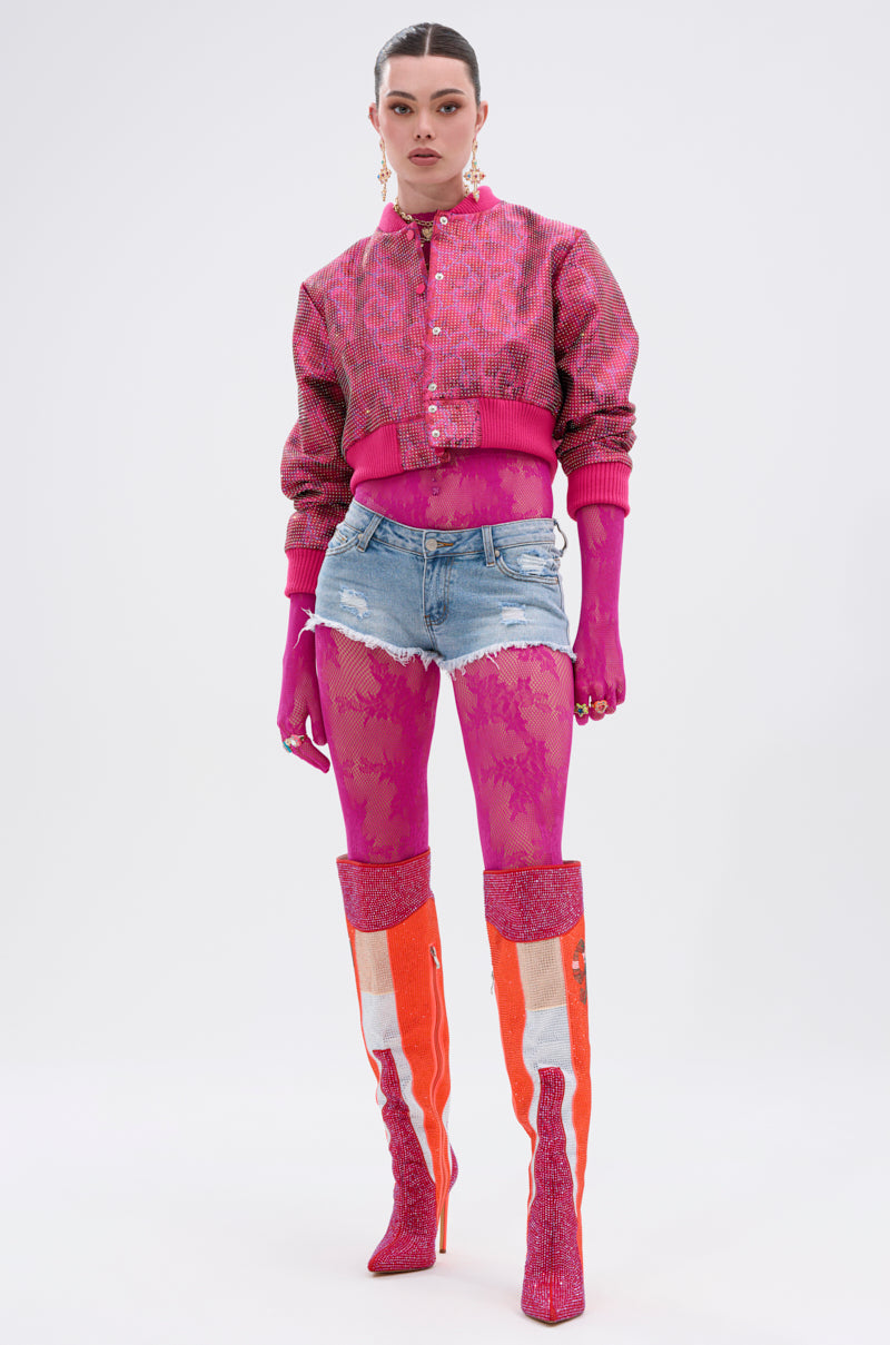 A model poses in the MAIN MOMENT STRETCH LACE JUMPSUIT with glitter boots, styled against a plain white background.