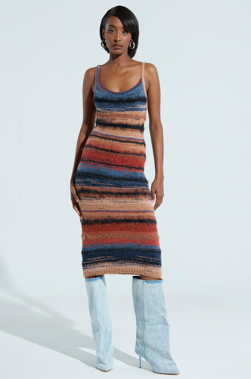 The UP ALL NIGHT MIDI DRESS by AKIRA Label exudes effortless chic with its form-fitting design and vibrant multicolor stripes in blue, orange, and brown. Paired against a light background, eye-catching light blue knee-high boots perfectly complete the ensemble.