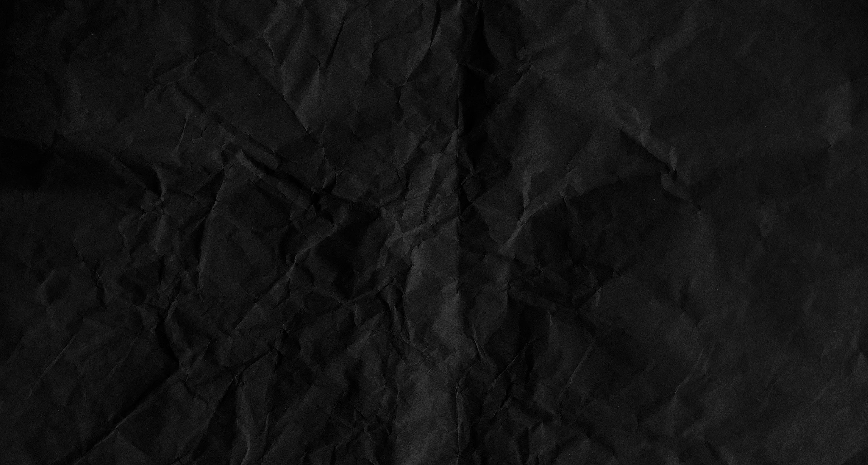 wrinkled up black paper