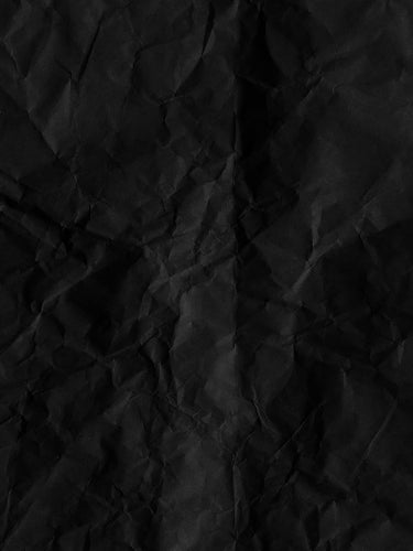 wrinkled up black paper