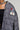 A person wearing the PLAYERS ONLY JERSEY BOMBER in textured black and white with metal buttons and athletic patches on the front. One of the patches reads 