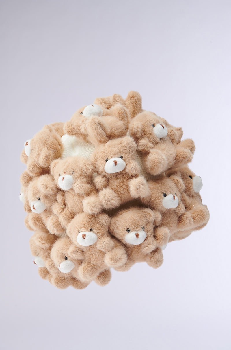 A cozy sphere crafted from numerous small, light brown Beanie-style teddy bear appliques floats against a plain white background. Each teddy has a cute expression, enhancing the whimsical and playful feel. Product: BEARY BABE BEANIE. 3