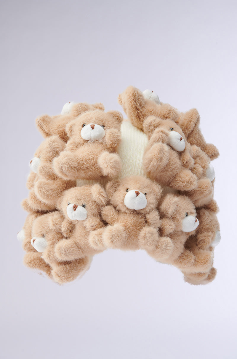 The BEARY BABE BEANIE is a cozy hat adorned with plush teddy bears featuring soft brown appliques on a light gray background. Each bear has a white snout and paws, giving it a textured, playful look reminiscent of your favorite beanie. 4