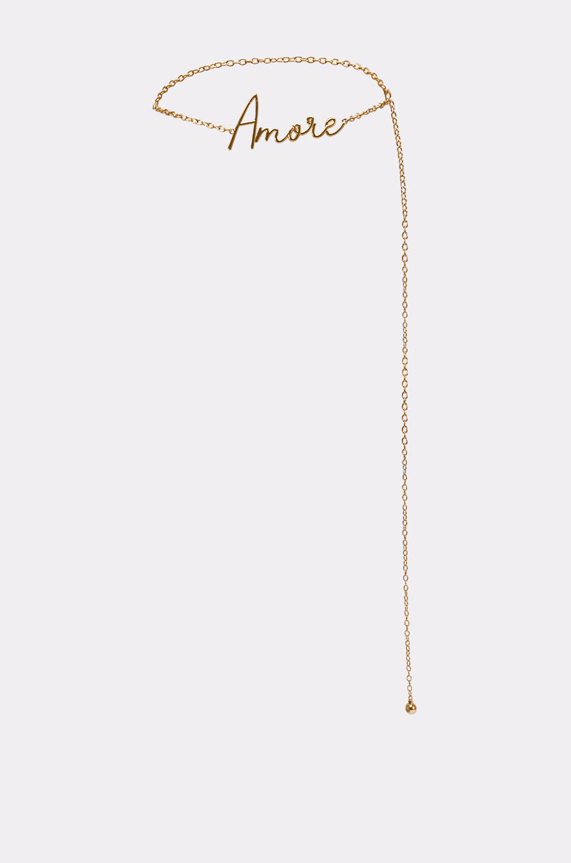 The AKIRA Label AMORE CHAIN BELT features the word "Amore" in gold cursive and an asymmetrical long drop chain with a small bead, showcased against a plain white background. 0