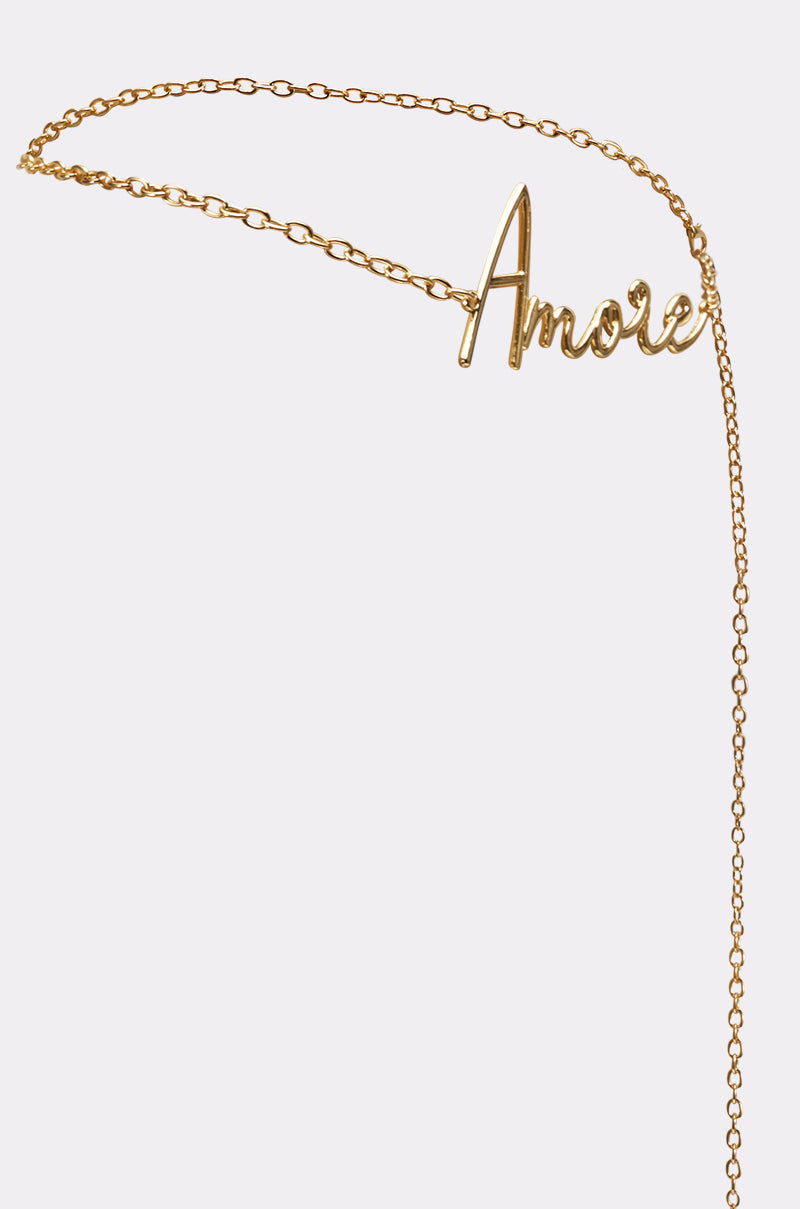 Inspired by the AMORE CHAIN BELT, this delicate gold necklace features a cursive "Amore" pendant, shown on a simple light background. 3