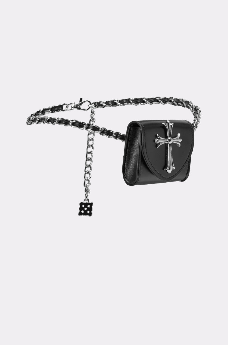 The CALL ME CHROME BELT BAG is a black faux leather belt bag with a small pouch, silver cross detail, and a hanging chain charm featuring a decorative cross-shaped design. 4
