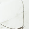 A close-up image of the delicate 2000 Rhinestone Year Necklace. The necklace features a pendant that spells out "2000," with each digit adorned with small, sparkling crystals. The fine chain sits on a light, neutral background.