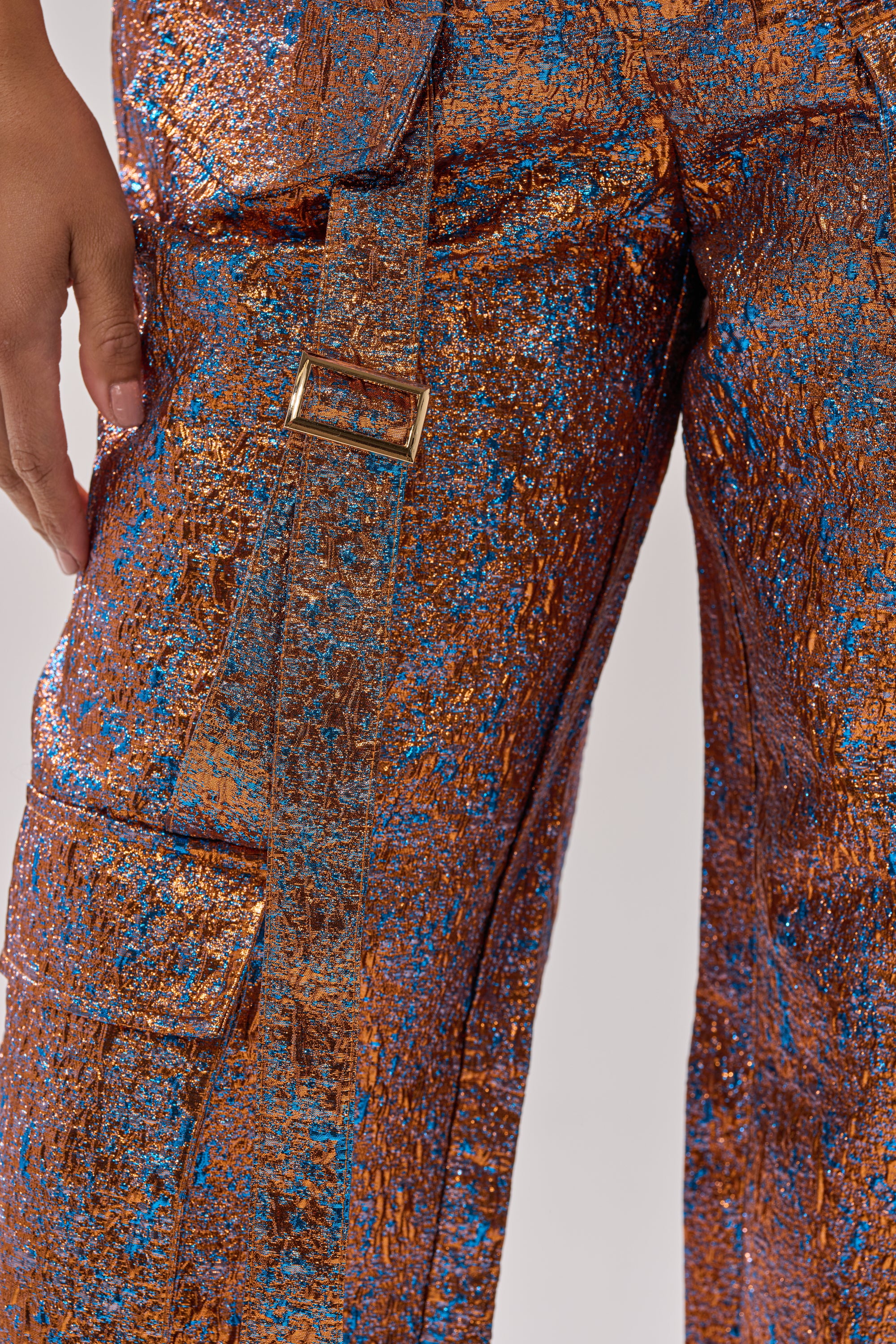 A person wearing CHECK IT OUT BROCADE BRONZE TROUSER, featuring a shiny metallic high-rise design. 9
