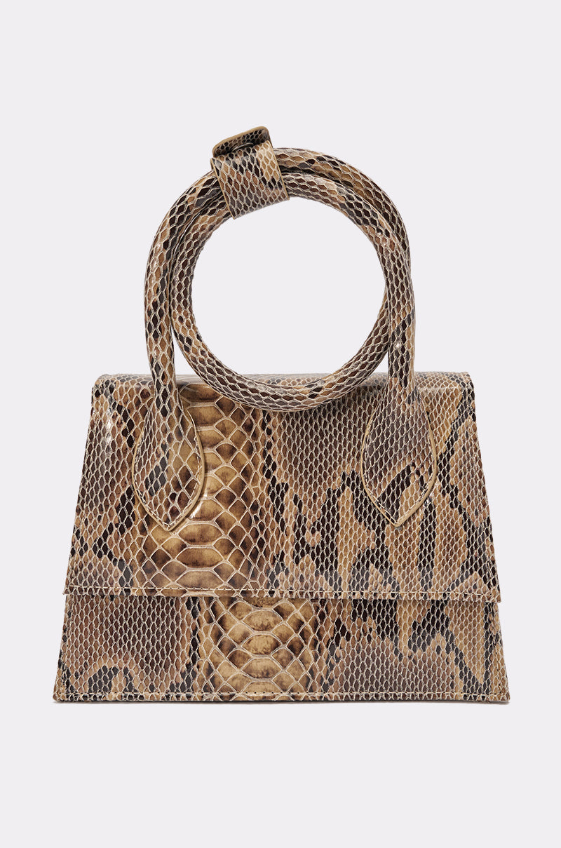 The IN THE WILD PURSE is a mini faux leather snakeskin handbag in brown and tan, featuring a geometric modern shape, large loop top handle, and front flap closure—perfect for adding a bold touch to any look. 4