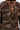 Close-up of a person wearing the COMFY COZY SWEATSHIRT JUMPSUIT IN CAMO, featuring an open back secured by two thin neckline ties. The stylish design highlights the upper back and part of the hair for a trendy lounge look.