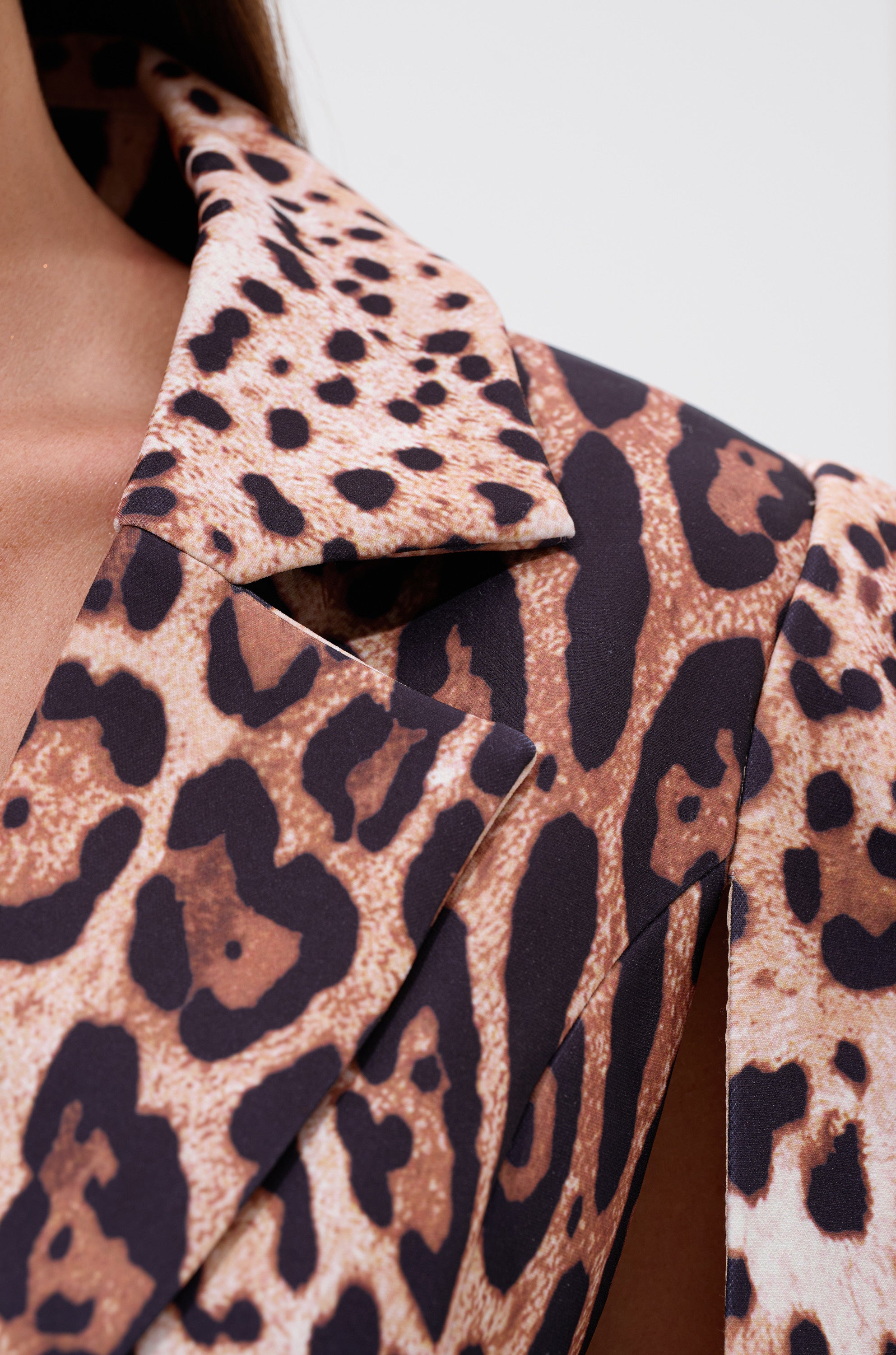 Close-up of the AMINAH LEOPARD PRINT BLAZER DRESS in bold brown and black, focusing on the lapel and shoulder to showcase its unique texture and chic mini blazer design.