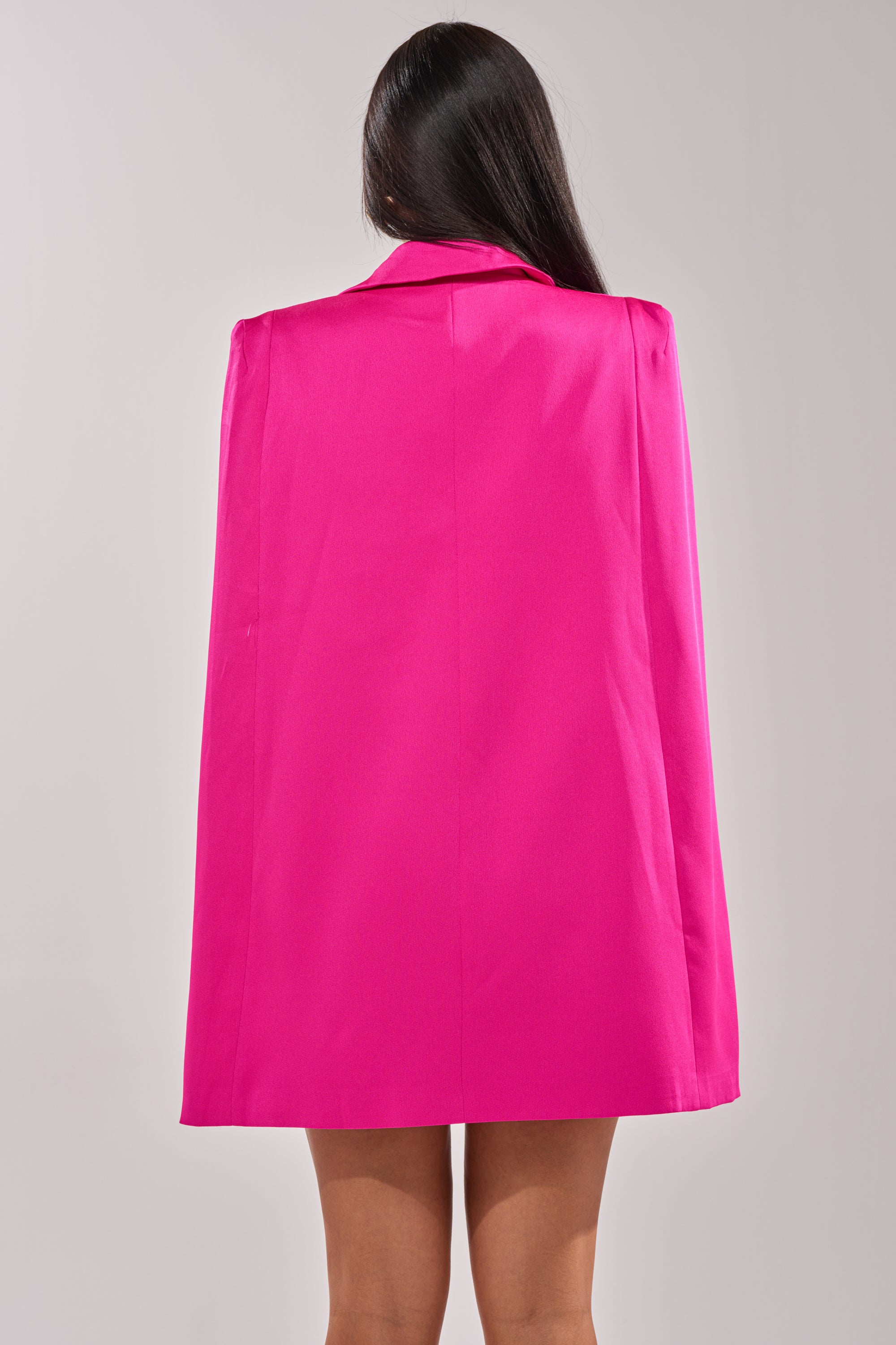 A person with long dark hair is seen from behind, wearing the A LA MODE MINI BLAZER DRESS IN PINK against a plain light background. 4