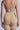 Back view of a person wearing TITSY TUMMY TUCK SHORTS IN TAN and a beige bra, standing against a neutral background.