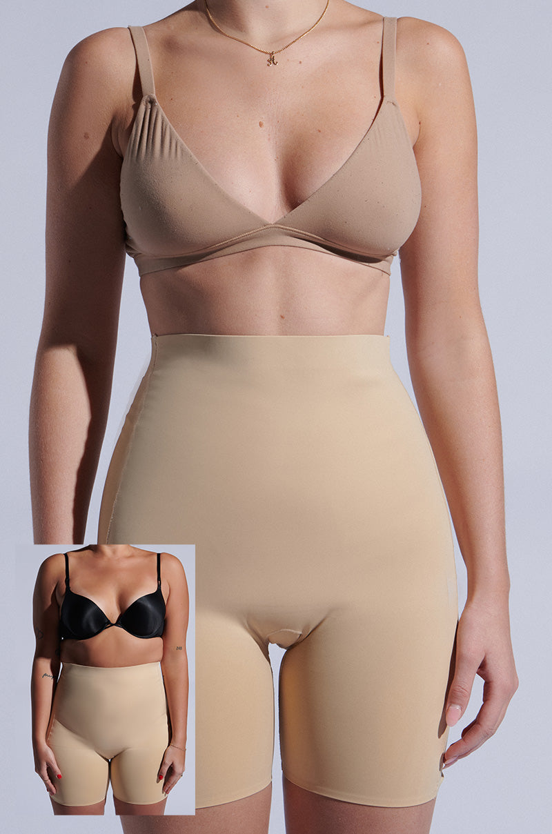 A person in high-waisted TAN TITSY TUMMY TUCK shorts and a nude bra is shown from the neck down. An inset reveals the same individual before wearing the shorts, in a black bra with noticeable midriff differences highlighted by their high-rise fit.