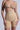 A person wearing the Titsy Tummy Tuck Shorts in tan, featuring a bralette and high-rise fit shorts, stands against a light background. The smooth, form-fitting shapewear boasts seamless hems for a sleek appearance.