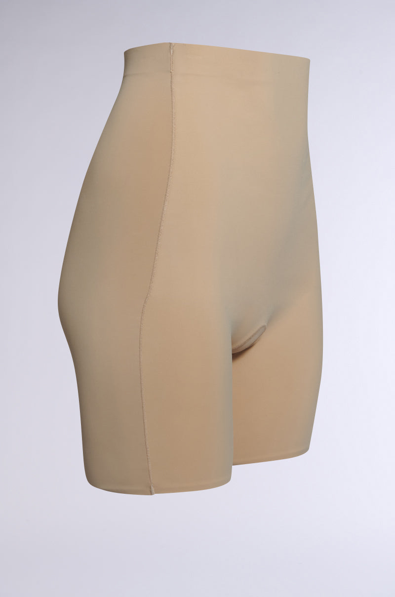 TITSY TUMMY TUCK SHORTS in tan, featuring seamless hems, shown against a plain background. The smooth, stretchy material contours the body with a flattering high-rise fit. 2