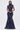A woman faces forward in the DONT MESS WITH ME COLLARED DENIM MAXI DRESS, a dark wash, sleeveless maxi with a high collar, front zipper from neck to hem, and utility pockets with zippers and flaps for a modern, functional style.