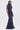 A woman stands against a white background wearing the DONT MESS WITH ME COLLARED DENIM MAXI DRESS, a sleeveless dark wash denim maxi with a high collar, front zipper, and multiple utility pockets on the bodice and skirt.