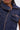 Close-up of a person wearing the DONT MESS WITH ME COLLARED DENIM MAXI DRESS, featuring a dark wash, copper zippers, utility pockets, two zippered chest pockets, and a large collar. Only the lower face and upper torso are visible.